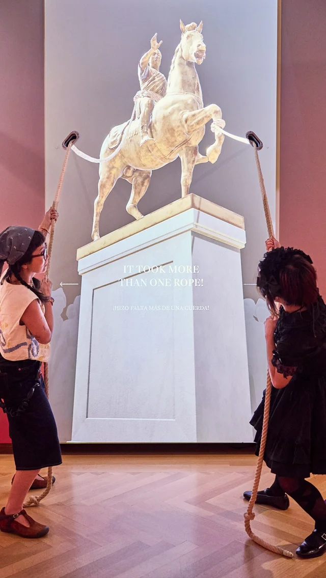 Some moments in history are best understood not by reading about them—but by physically experiencing them.

For the Museum of the City of New York’s “The Occupied City: New York and the American Revolution” exhibition, we designed The Toppling of King George III at Bowling Green—an interactive installation that invites visitors to work together to pull down the king’s 4,000-pound statue using a pair of real hemp ropes.

Behind the scenes, a custom digitally encoded pulley system generates haptic feedback, allowing visitors to feel the weight and resistance of the monument as they pull.

Rather than simply telling history, we wanted visitors to embody it—to experience the collective effort, symbolism, and emotion behind one of the defining acts of the American Revolution.

This project reminds us that the most memorable museum experiences happen when storytelling extends beyond the screen and into the body.

Client: @museumofcityny
Exhibition: The Occupied City: New York and the American Revolution
Team: @kudosnyc @kasa_made
Creative Lead: @jkudos Robert de Saint Phalle
Video Direction: Samuel Morgan
Cinematographer: Fahnon Bennett

#MuseumDesign #ExperienceDesign #InteractionDesign #ExhibitionDesign HumanCenteredDesign CreativeTechnology MCNY AmericanRevolution